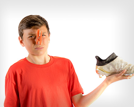 A Boy Holding a Smelly Sports Sneaker
